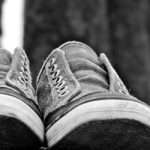 A black-and-white close-up photo of a pair of plimsolls.
